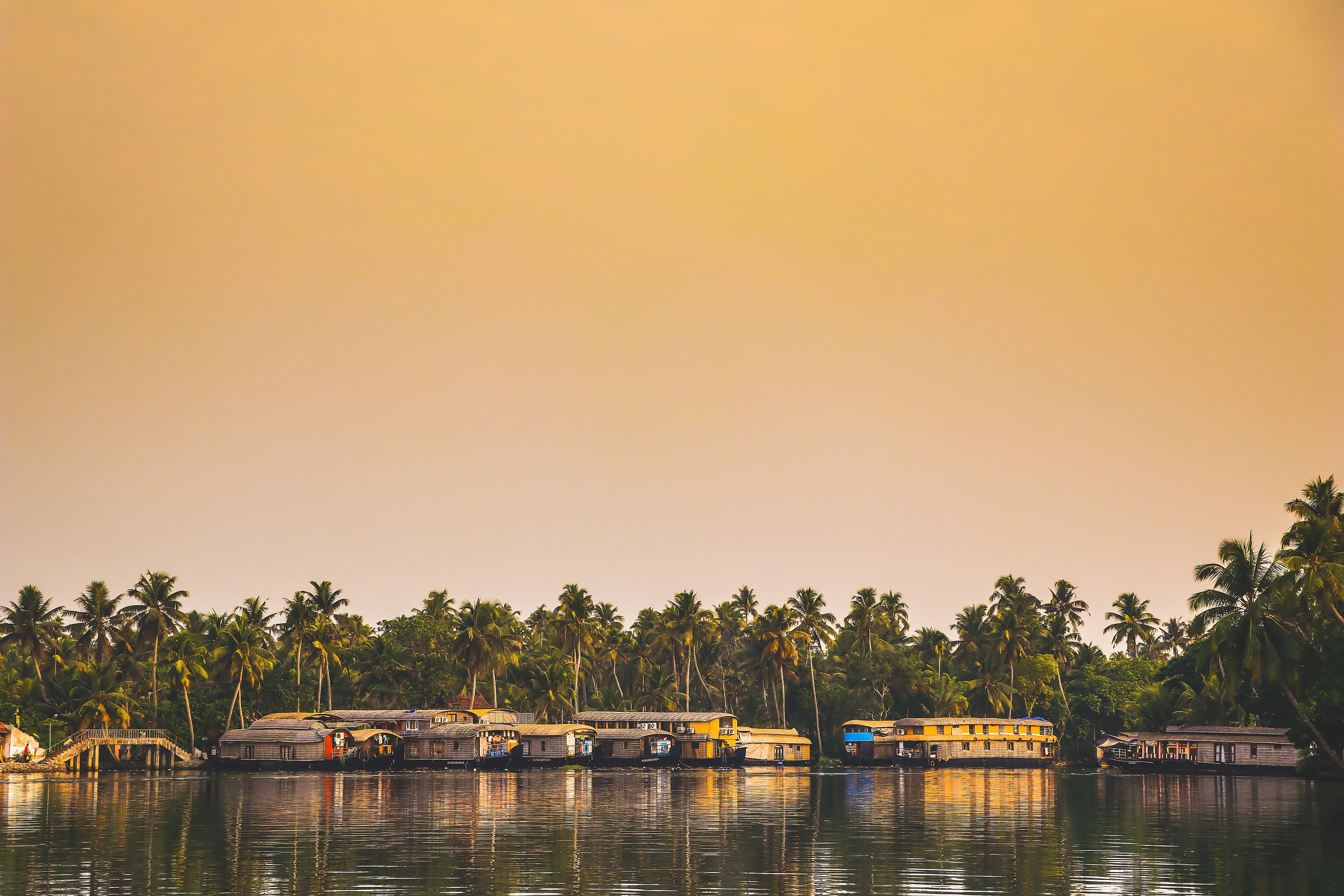 A Kettuvallam houseboat cruising the palm-fringed Alleppey backwaters at Punnamada, Kerala